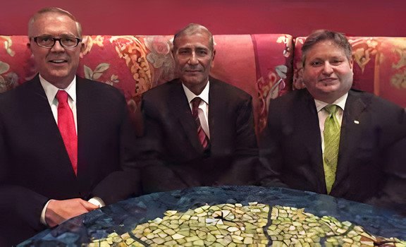 two US pilots sitting together with their Iraqi captor